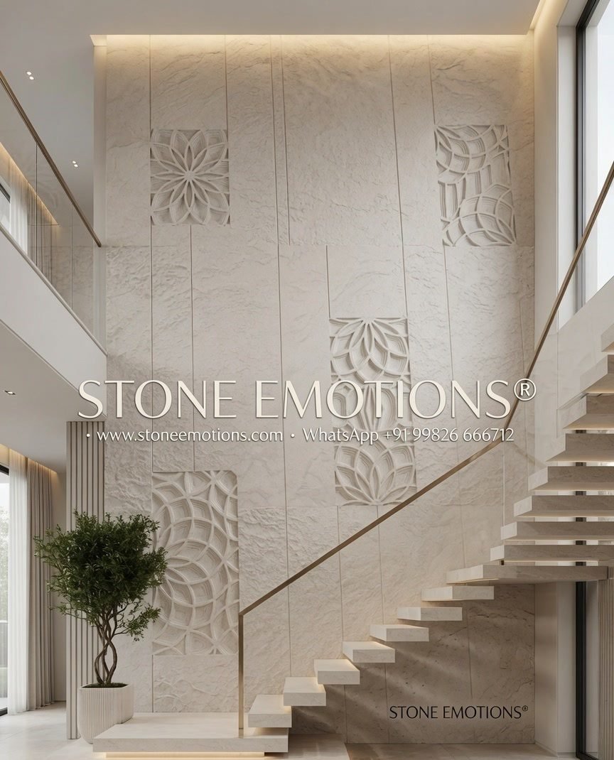 Double-height natural stone staircase wall with scattered square carved motif panels beside a cantilever stair