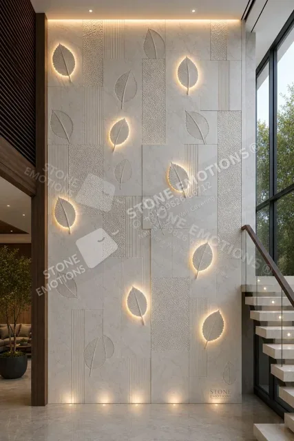 Falling leaves pattern carved into white marble feature wall